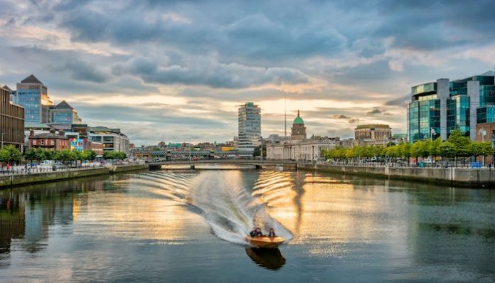 Motorboat speeding on River Liffey Dublin Ireland