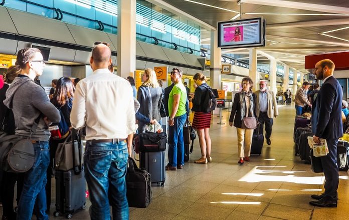 People queue at Tegel Airport check-in (HDR)